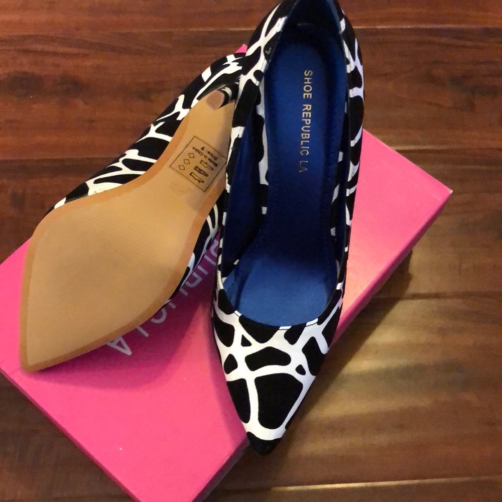 Black and white heels never worn. New with box